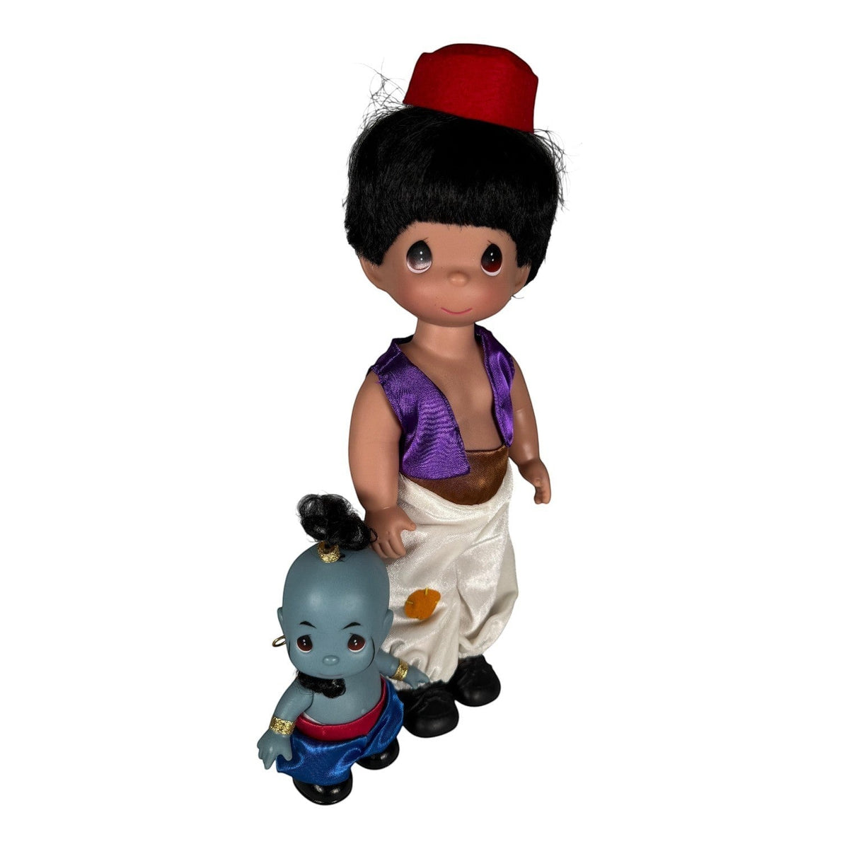 The Doll Maker 12-inch Aladdin doll with red fez and purple vest alongside a 5-inch blue Genie figure.