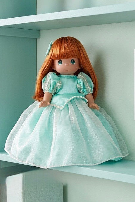 The Doll Maker 12-inch Ariel doll with long red hair wearing a shimmering mint green gown on a shelf