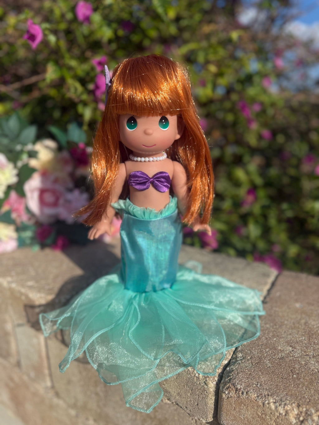 The Doll Maker 12-inch Ariel mermaid doll with vibrant red hair, purple seashell top, and shimmering teal tail.