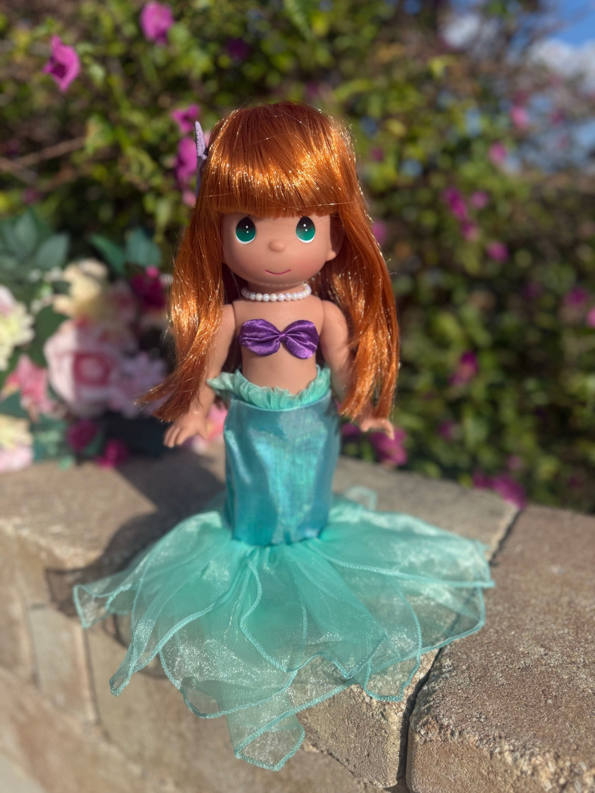 The Doll Maker 12-inch Ariel mermaid doll with vibrant red hair, purple seashell top, and shimmering teal tail.