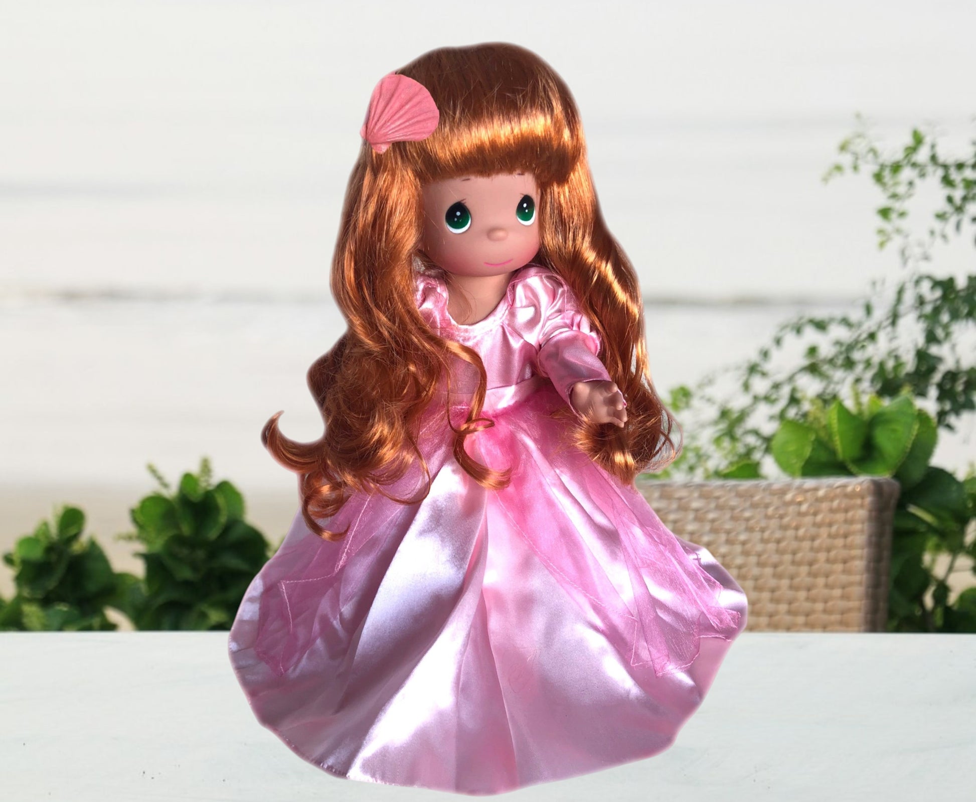 The Doll Maker Sweet Dreamer Ariel 12-inch doll with long red hair and a pink satin gown with a seashell hair clip.