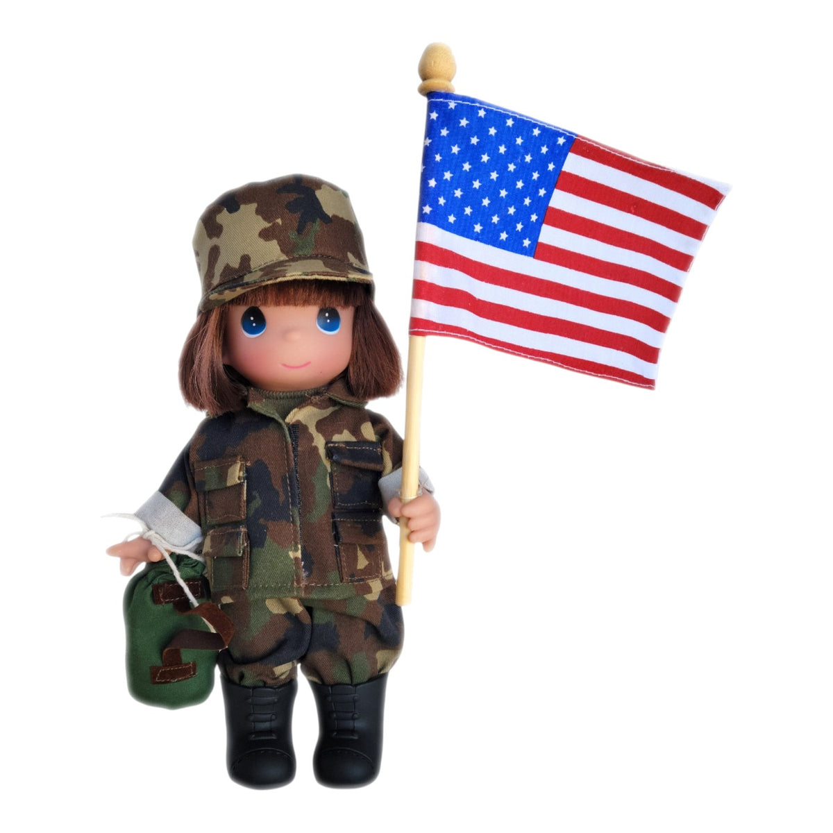 The Doll Maker 9-inch Army Girl vinyl doll wearing camouflage uniform and cap, holding an American flag and canteen.