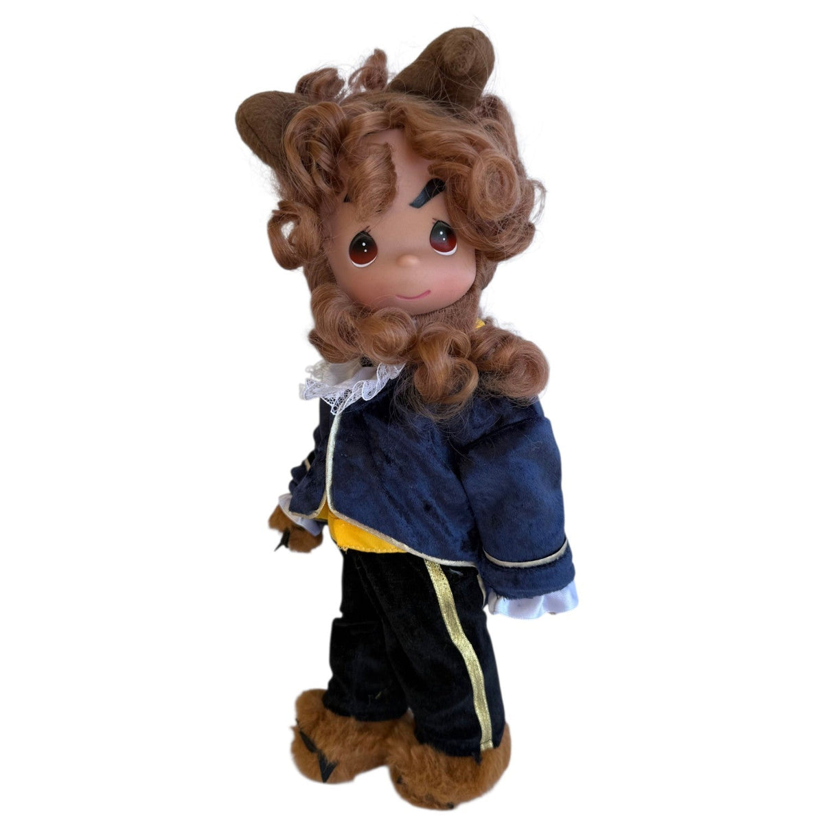 The Doll Maker 12-inch Beast doll with brown curly hair, wearing a navy blue velvet jacket and black trousers.