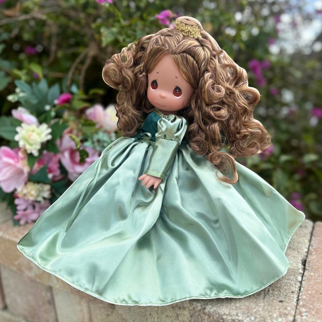 The Doll Maker 12-inch Beautiful Belle doll with curly brown hair wearing a shimmering sage green satin gown.