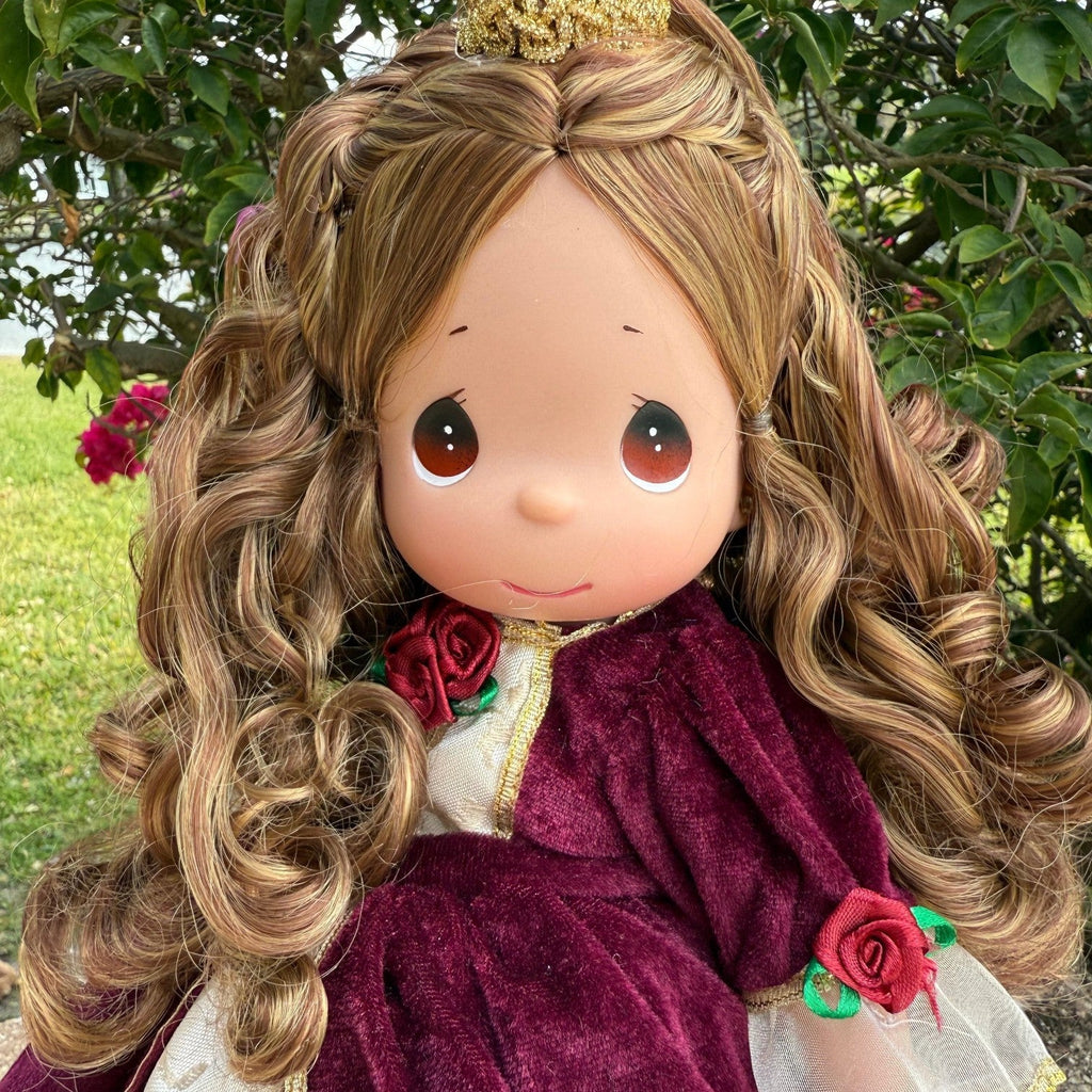 The Doll Maker 12-inch Belle doll wearing a burgundy velvet Christmas dress with rose accents and a gold crown.