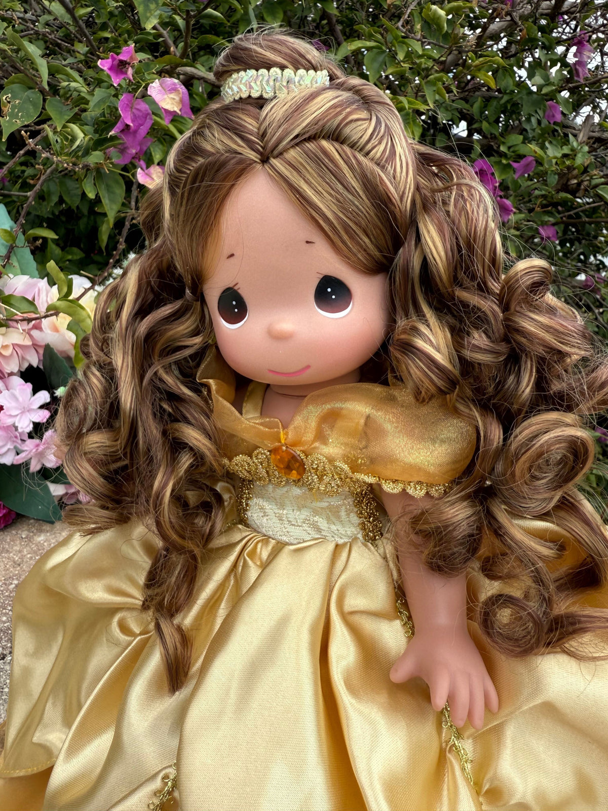 The Doll Maker 12-inch Belle Elegance collectible doll wearing an elegant gold gown with detailed curly brown hair.