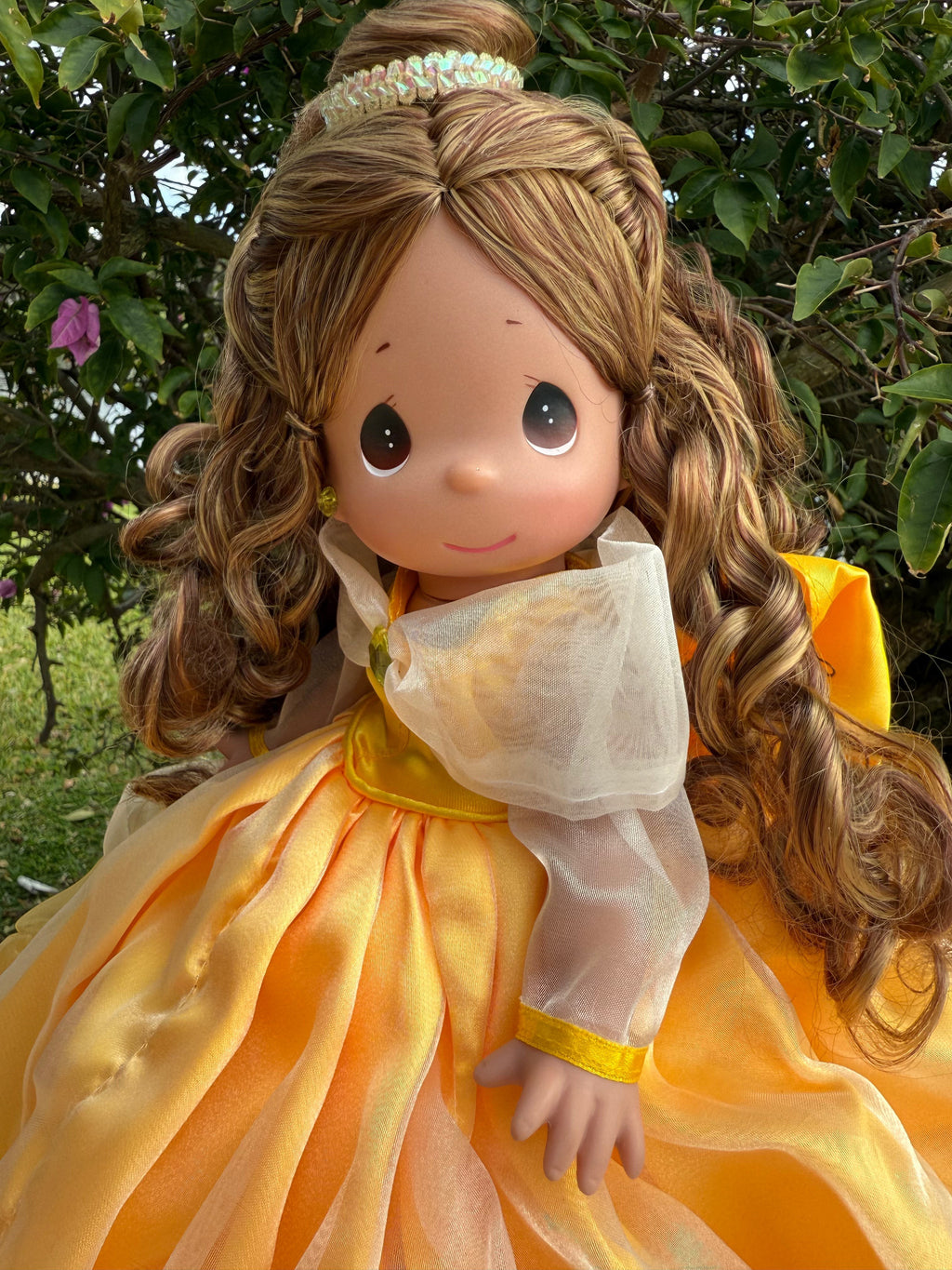 The Doll Maker 12-inch Belle doll wearing a yellow ball gown with sheer sleeves and long wavy brown hair