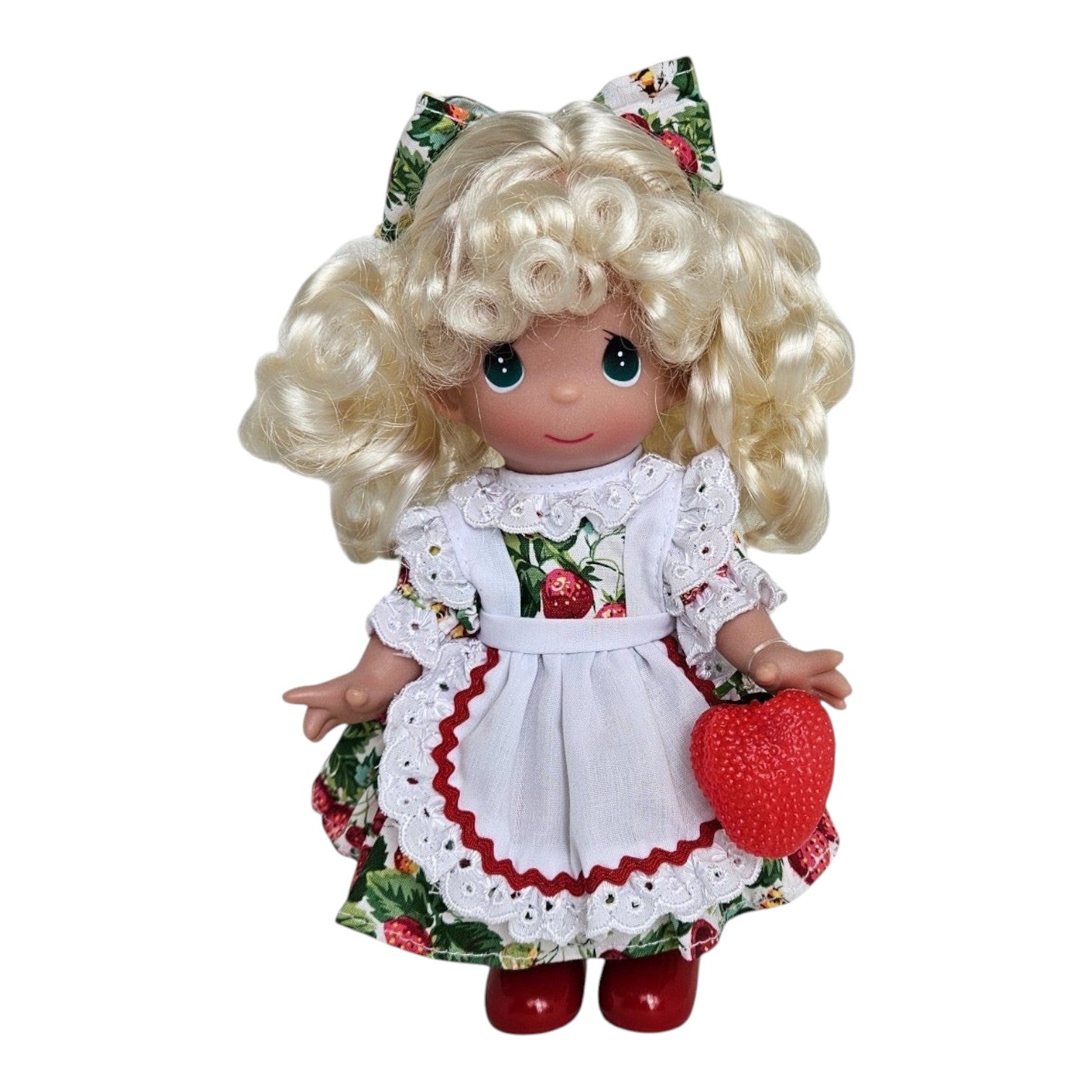 The Doll Maker You’re Berry Sweet 9-inch vinyl doll with blonde curls, strawberry print dress, and white apron.