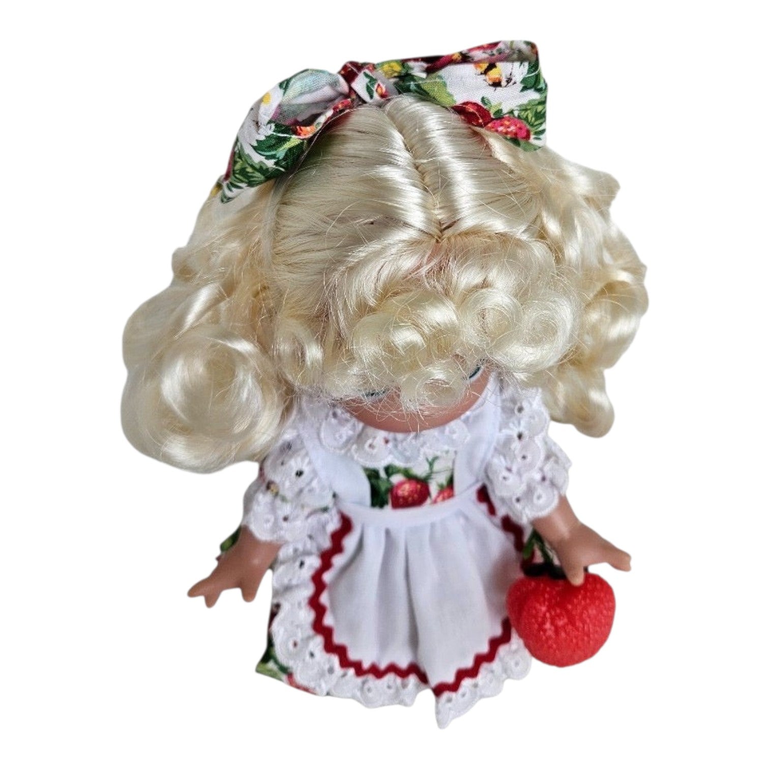 The Doll Maker You’re Berry Sweet 9-inch vinyl doll with blonde curls, strawberry print dress, and matching hair bow.