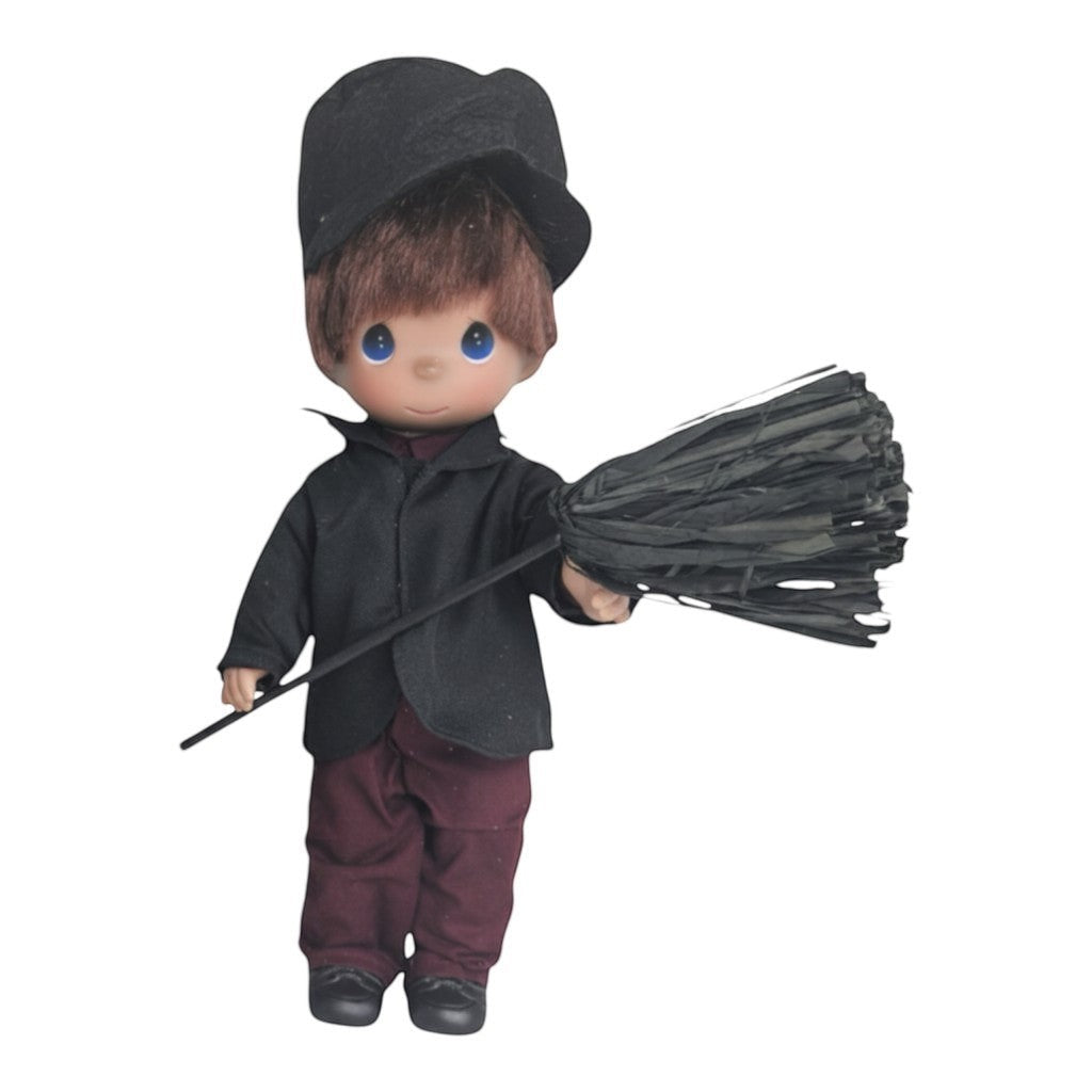 The Doll Maker 12-inch Bert chimney sweep doll from Mary Poppins wearing a black jacket, cap, and maroon trousers.