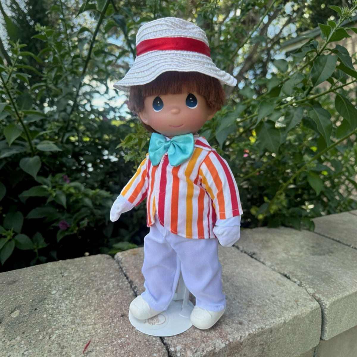 The Doll Maker 12-inch Bert doll from Mary Poppins wearing a striped jacket, white trousers, and a straw hat.