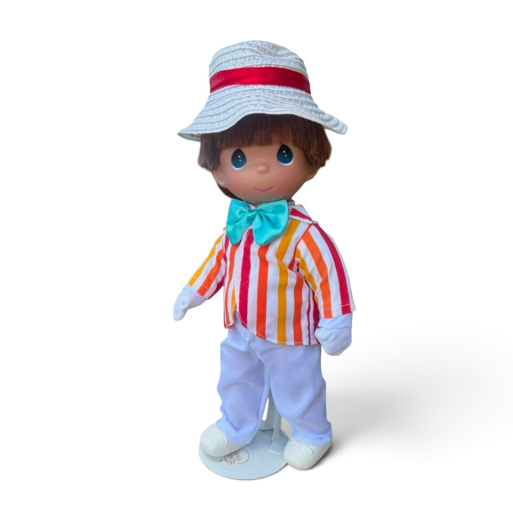 The Doll Maker 12-inch Bert doll from Mary Poppins wearing a striped jacket, white trousers, and a straw boater hat.