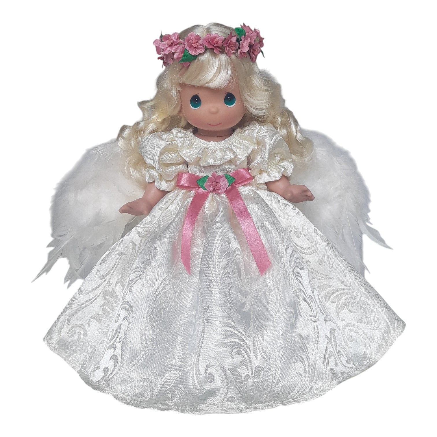 The Doll Maker 16-inch blonde angel doll wearing a white satin dress with pink ribbon and a floral crown.