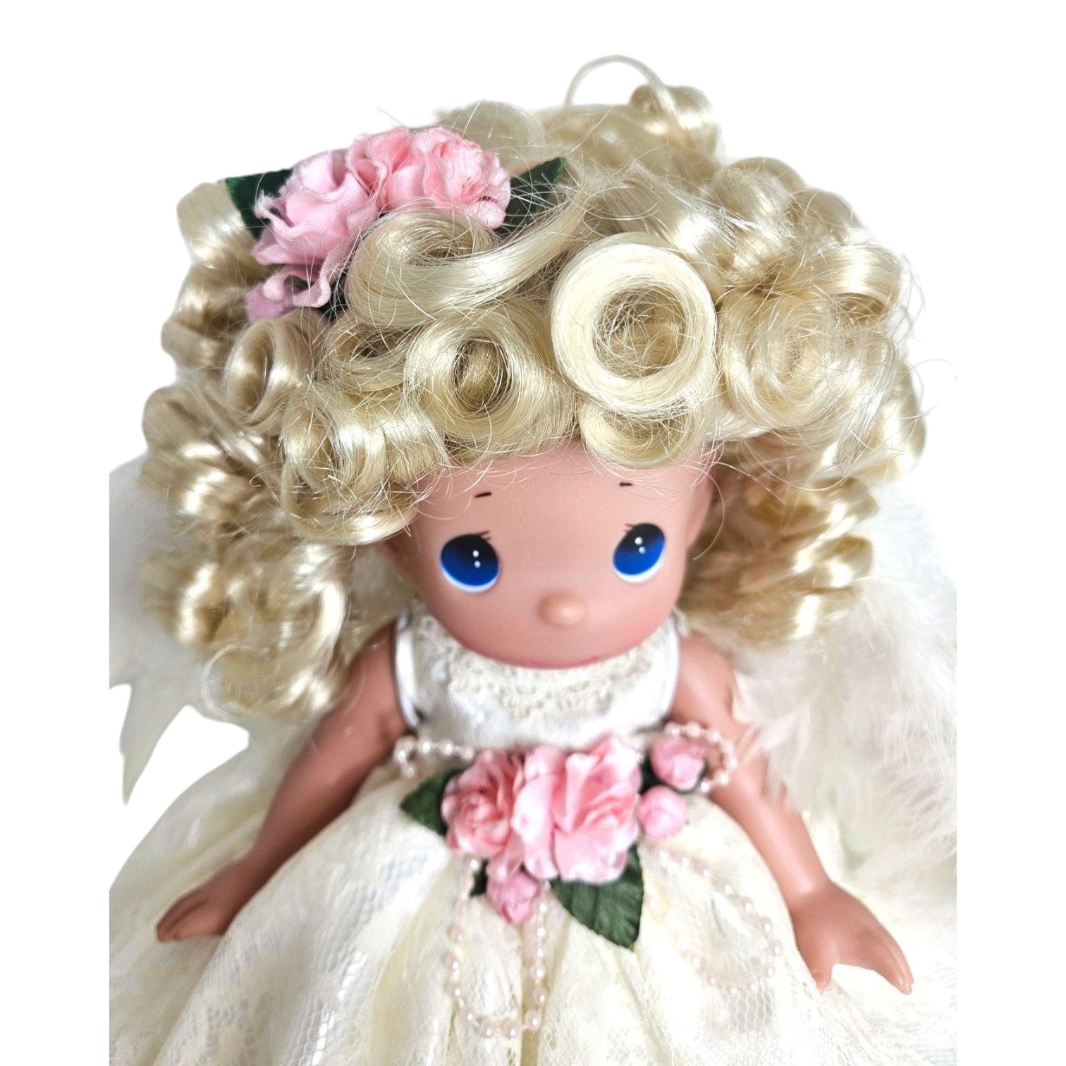 The Doll Maker 12-inch blonde angel doll wearing a white lace dress with pink floral accents and feathered wings