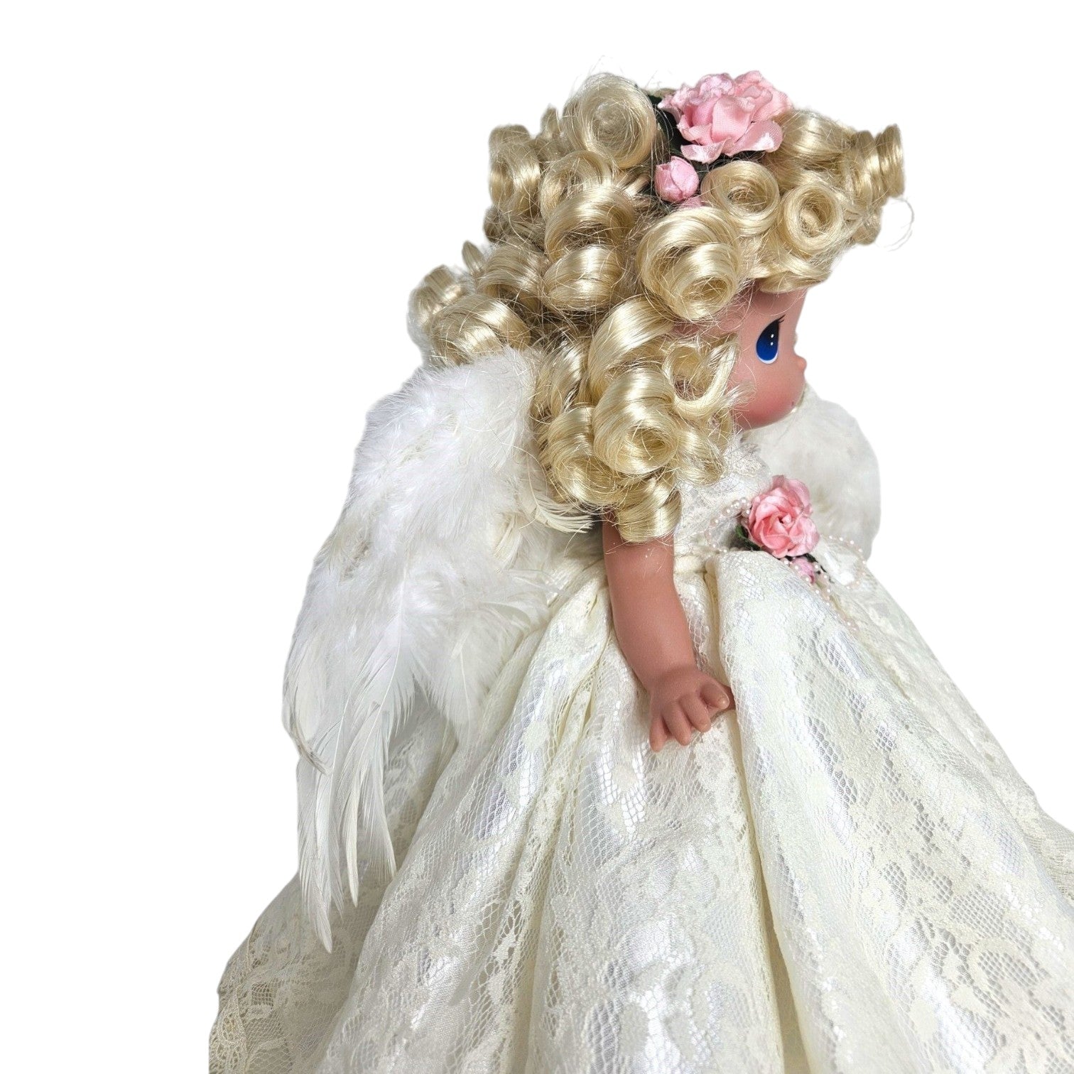 The Doll Maker 12-inch blonde angel doll wearing a white lace dress with feathered wings and pink floral accents