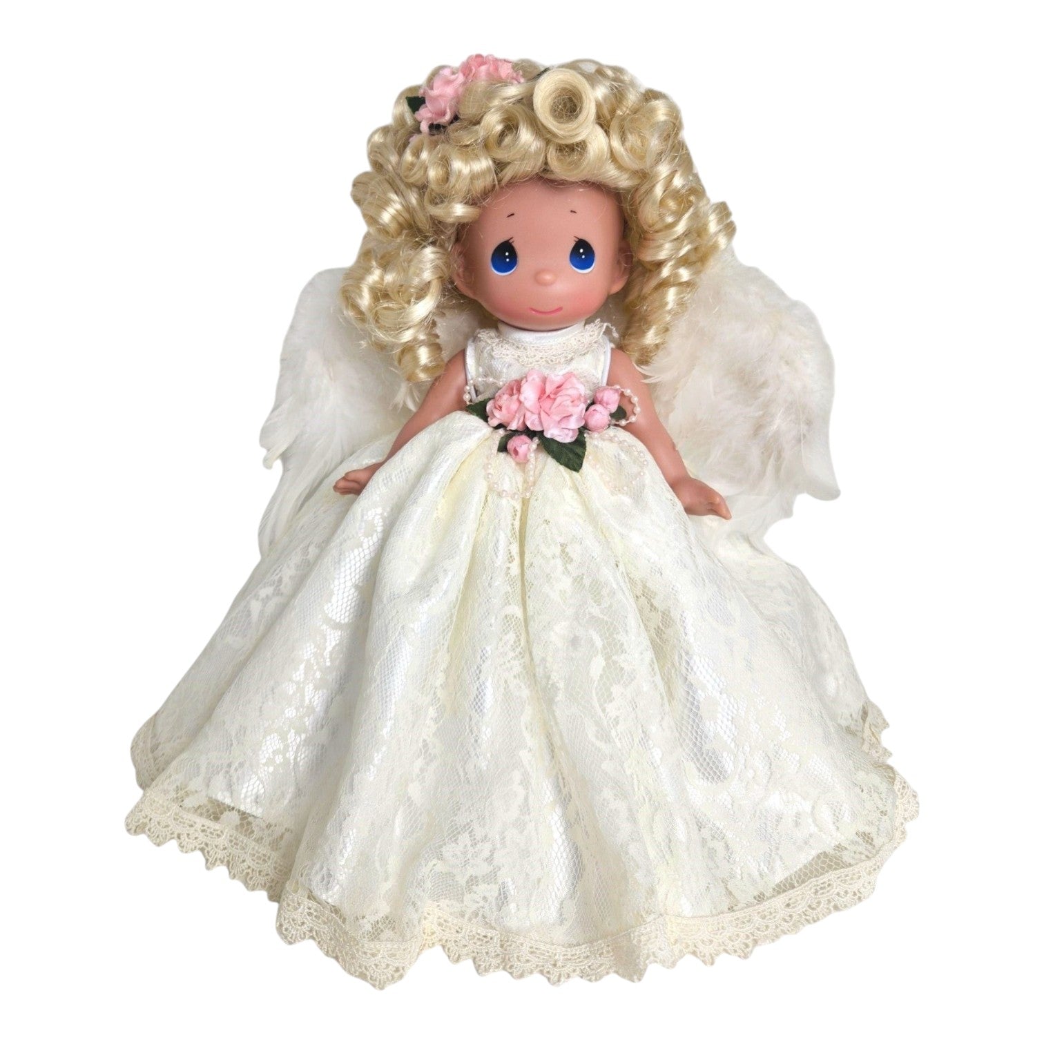 The Doll Maker 12-inch blonde angel doll wearing a white lace dress with feathered wings and pink floral accents.