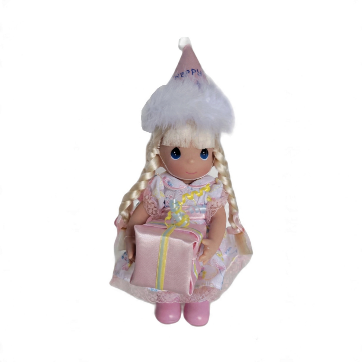 The Doll Maker 7-inch blonde vinyl birthday doll wearing a party hat and holding a pink gift box.