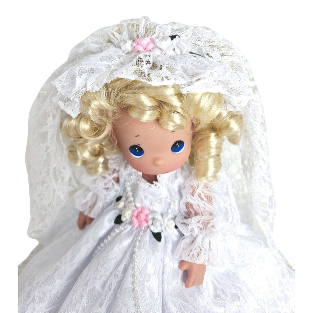 The Doll Maker Fairytale Come True blonde bride doll wearing a white lace wedding dress and veil with floral accents.