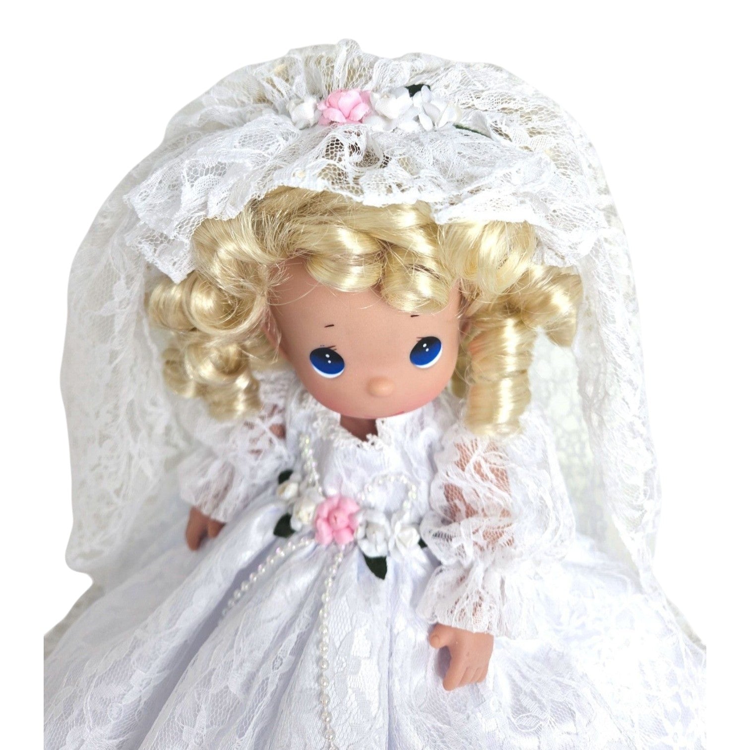 The Doll Maker Fairytale Come True blonde bride doll wearing a white lace wedding dress and veil with floral accents.