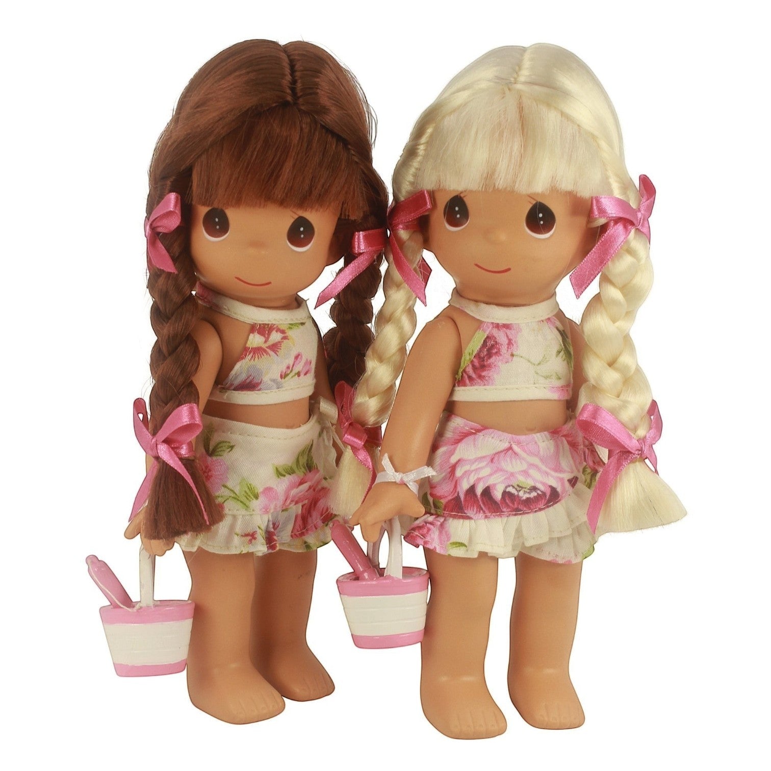 The Doll Maker 9-inch vinyl dolls with blonde and brunette hair wearing floral outfits and holding sand buckets