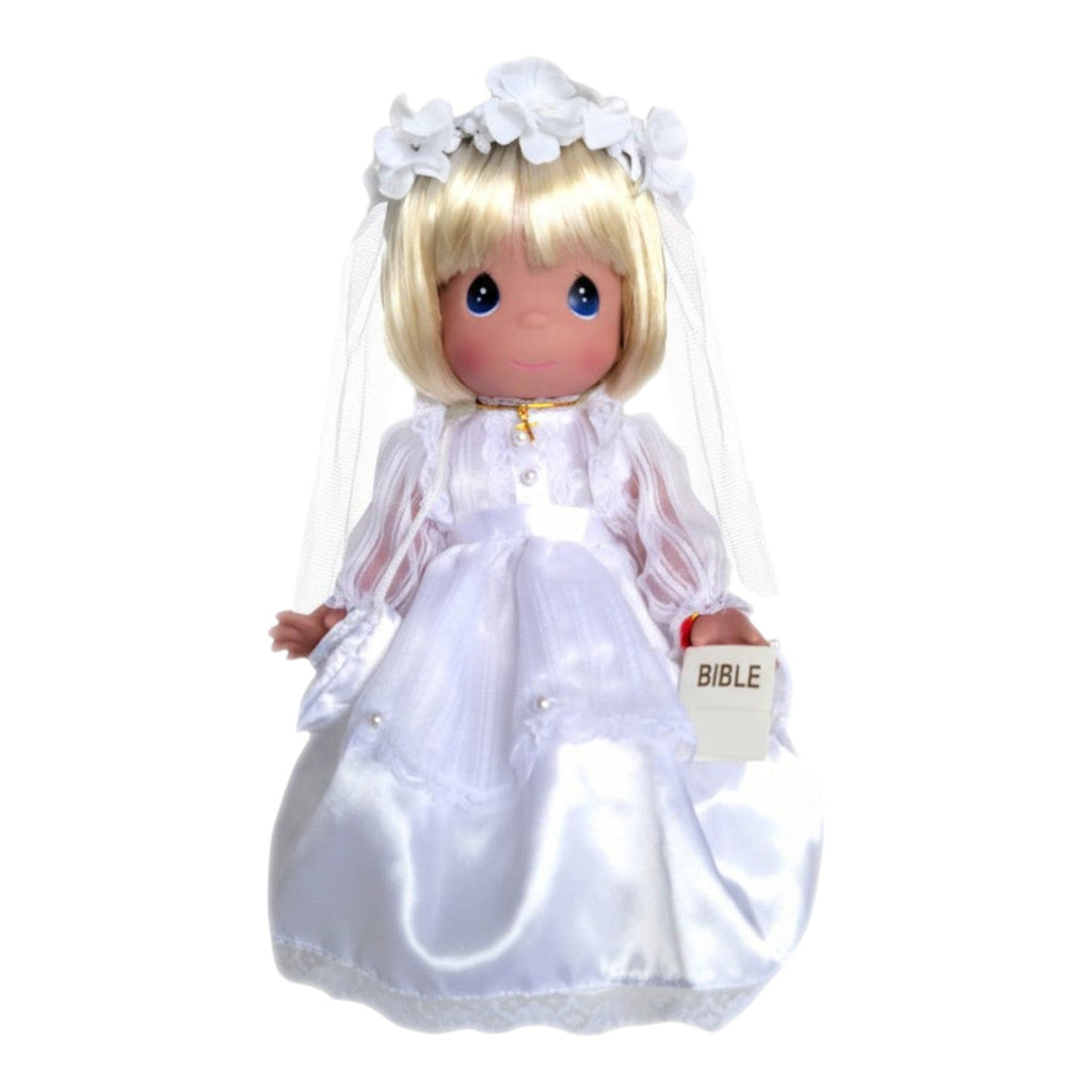The Doll Maker 12-inch blonde communion doll wearing a white satin gown, veil, flower crown, and gold cross necklace.