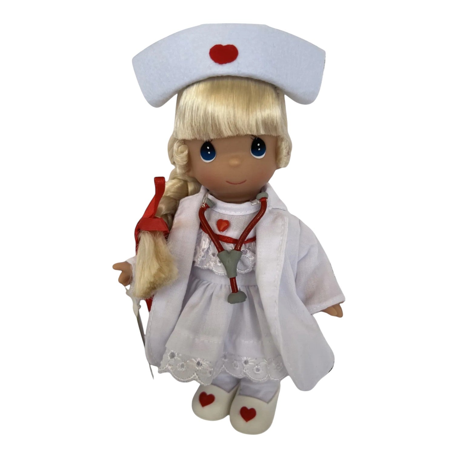 The Doll Maker Loving Touch blonde nurse doll wearing a white uniform with red heart accents and a stethoscope