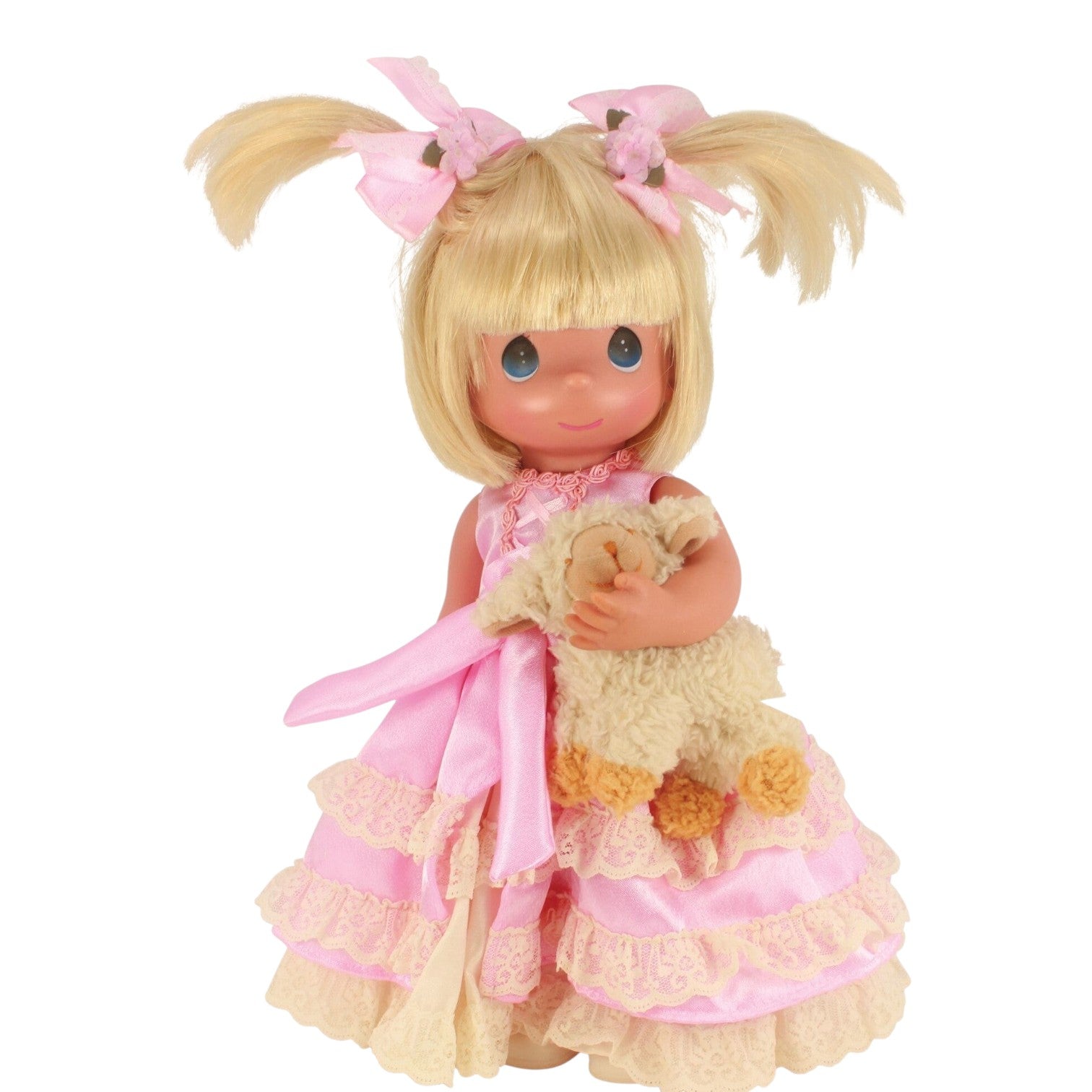 The Doll Maker Pretty in Pigtails 12-inch blonde vinyl doll wearing a pink dress and holding a plush lamb toy