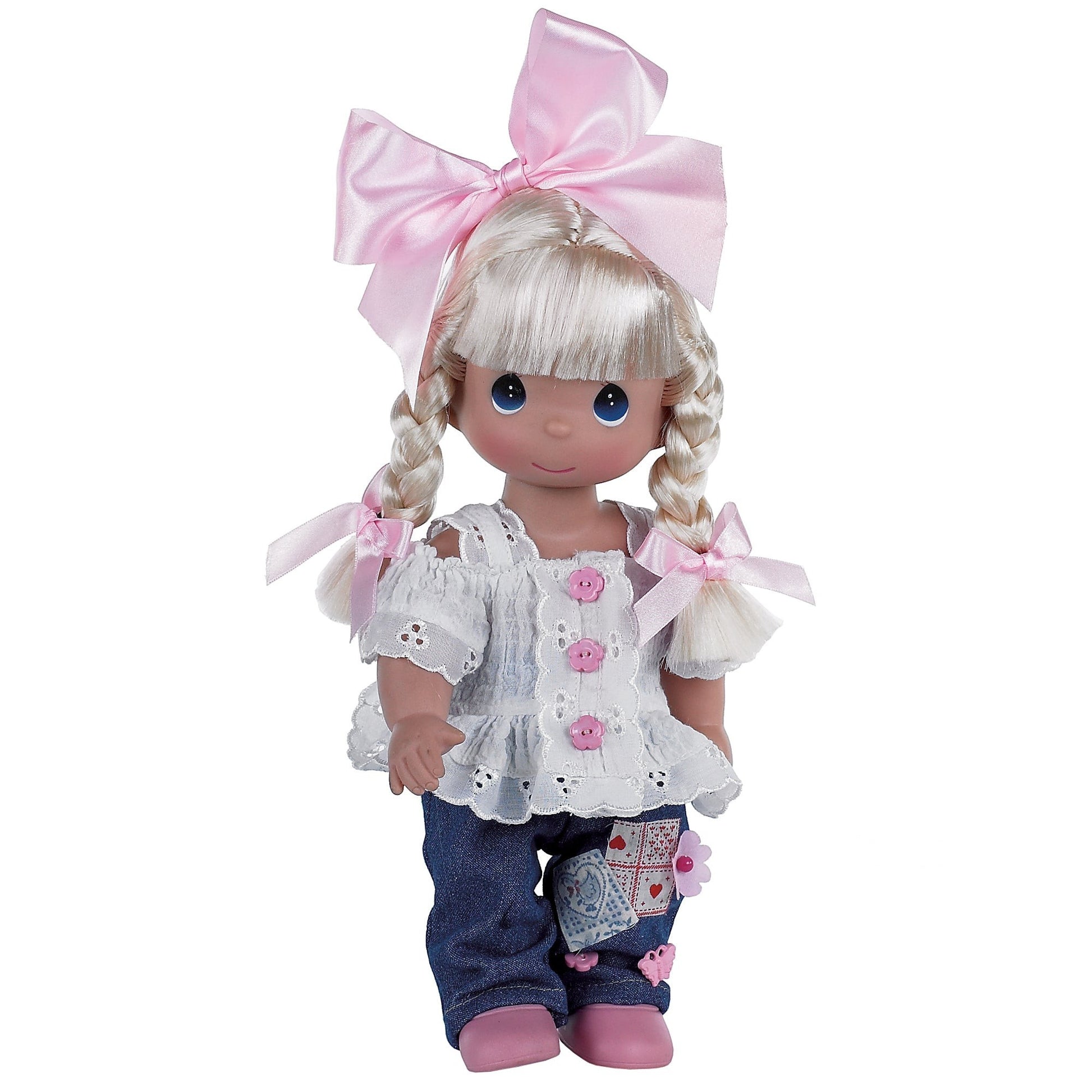 The Doll Maker Cute as a Button 12-inch blonde vinyl doll wearing a white eyelet top, denim jeans, and a pink bow.