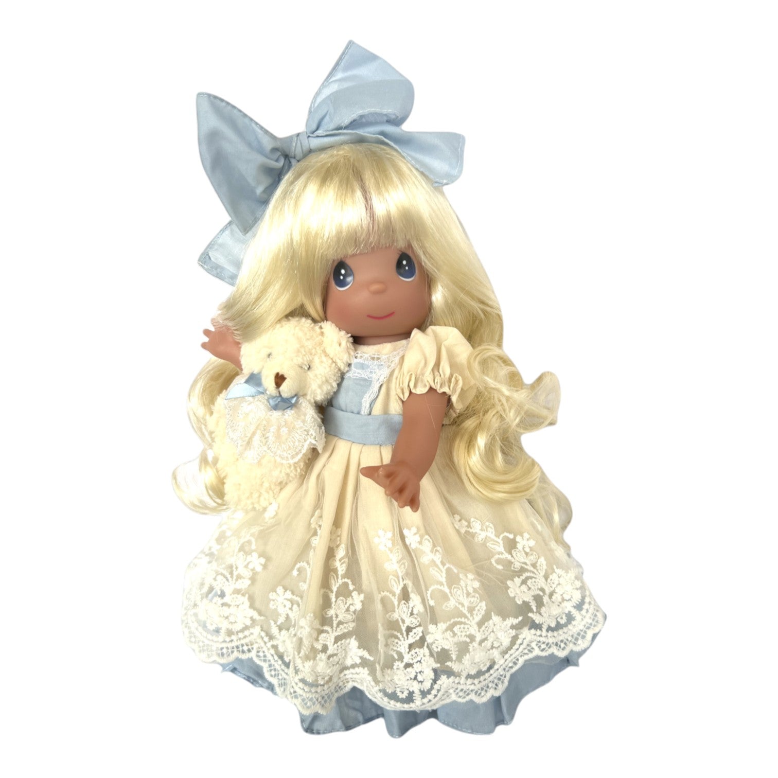The Doll Maker Isn't she Lovely 12-inch blonde vinyl doll wearing a cream lace dress with a blue bow and teddy bear