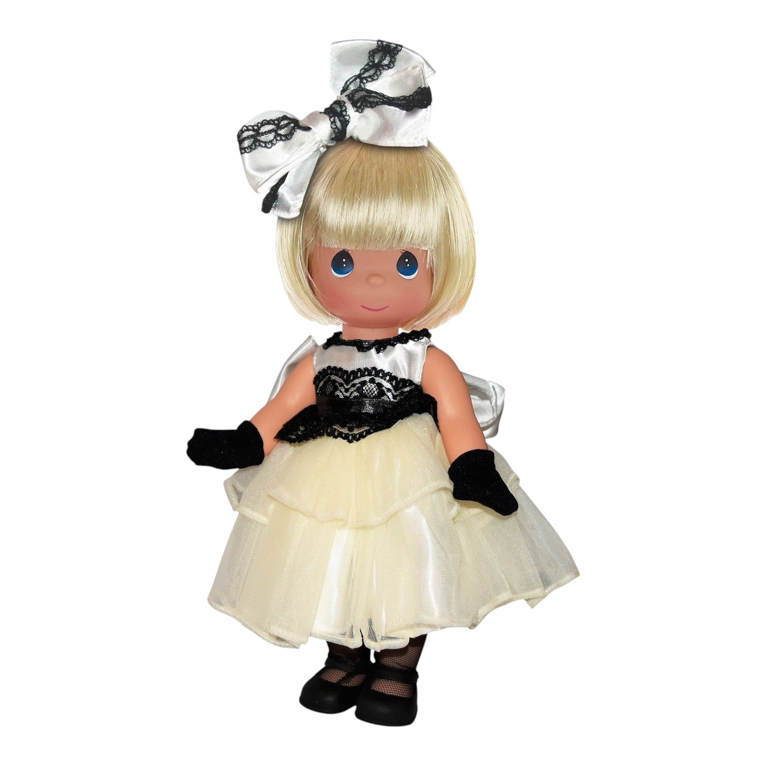 The Doll Maker Elegantly Yours blonde vinyl doll wearing a white and black gown with lace details and a matching bow.