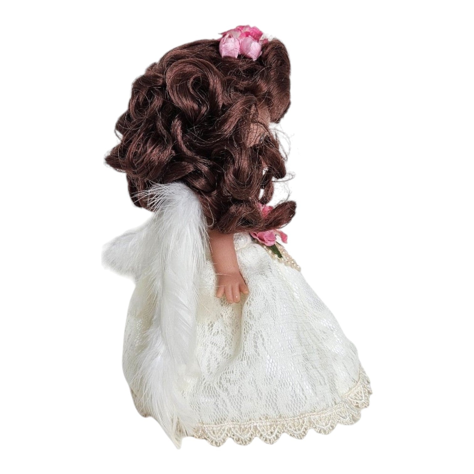 The Doll Maker 7-inch brunette angel doll wearing a white lace dress with pink floral accents and white feather wings.