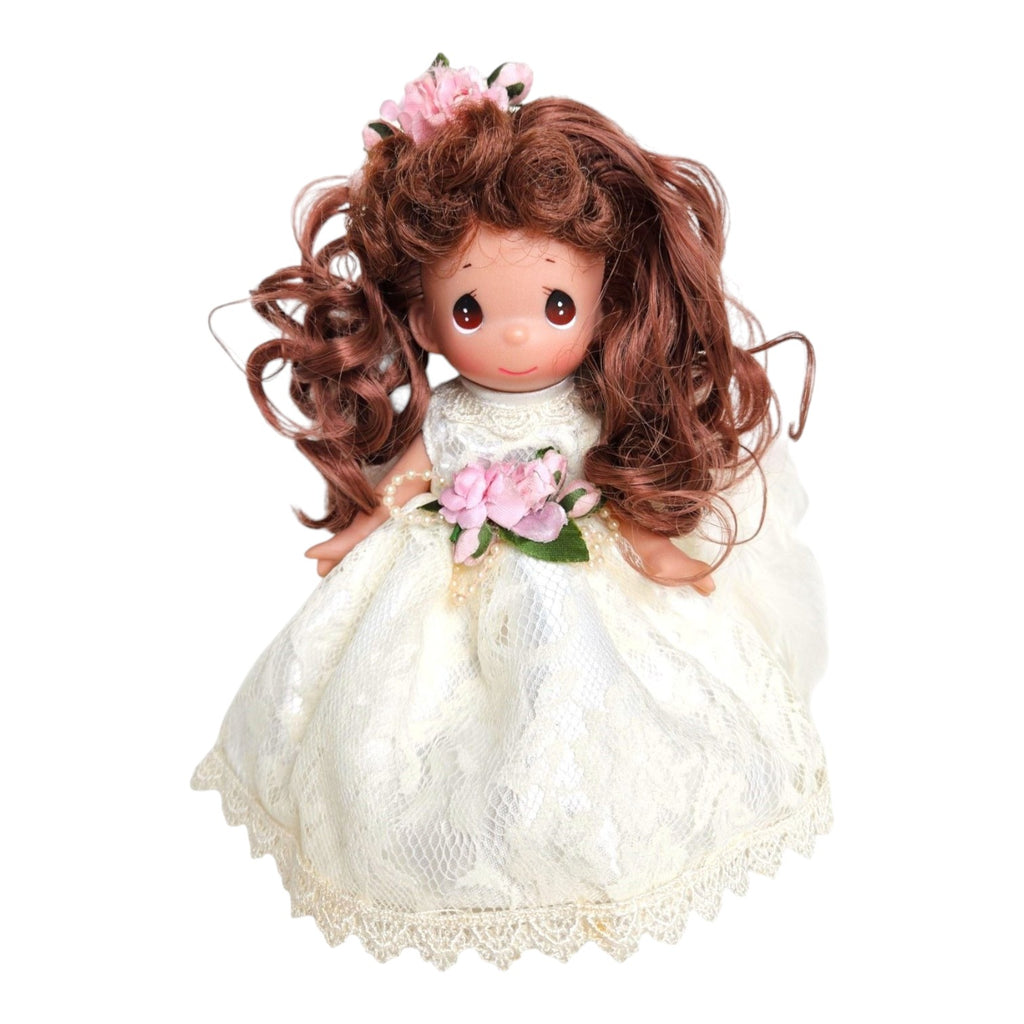 The Doll Maker 9-inch brunette angel doll wearing a white lace dress with pink floral accents and feathered wings.
