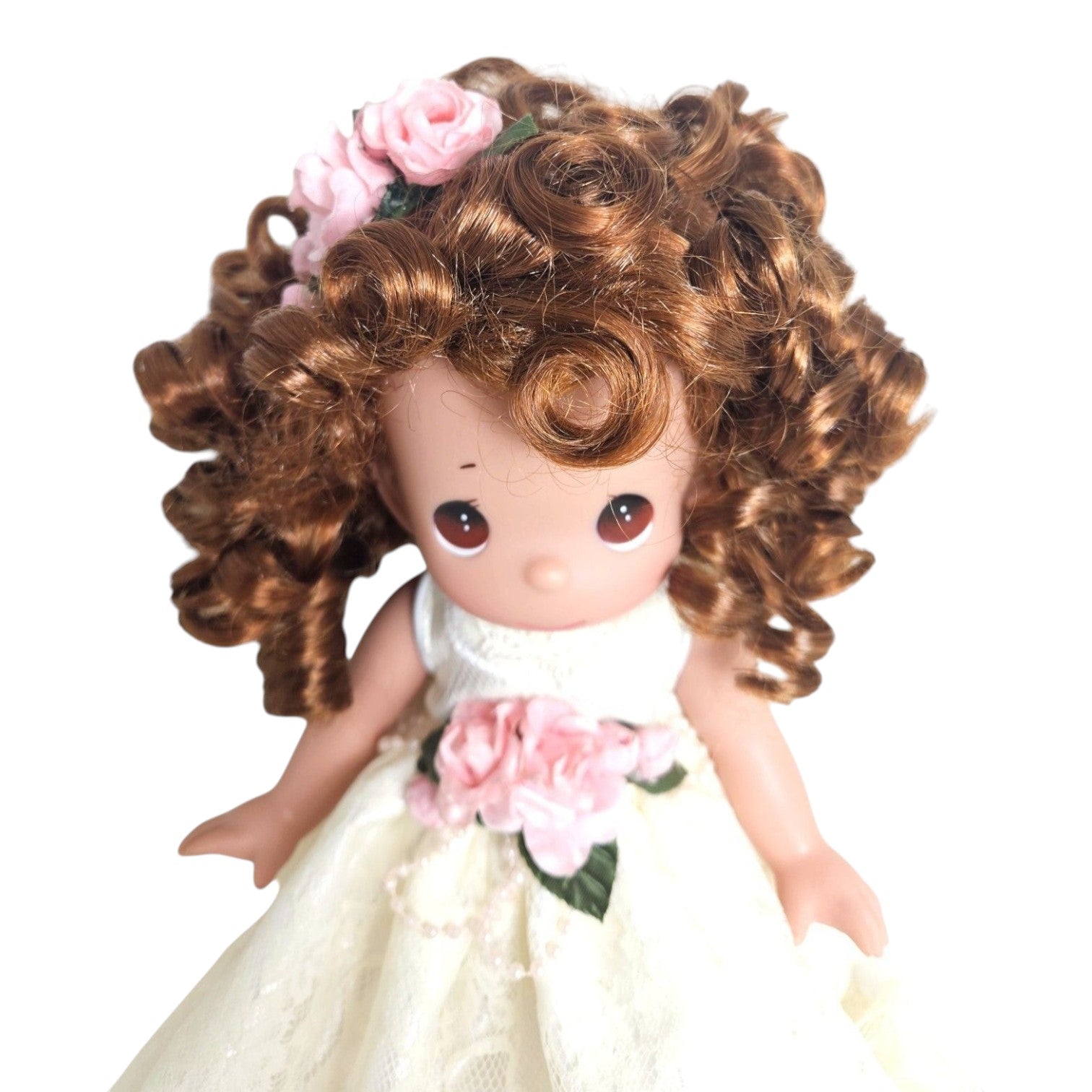 The Doll Maker 12-inch brunette angel doll wearing a white lace dress with pink floral accents and curly hair