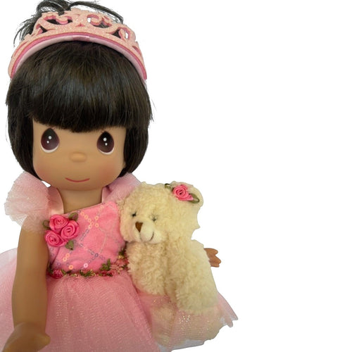 The Doll Maker 12-inch brunette ballerina doll wearing a pink tutu and tiara, holding a small plush teddy bear.
