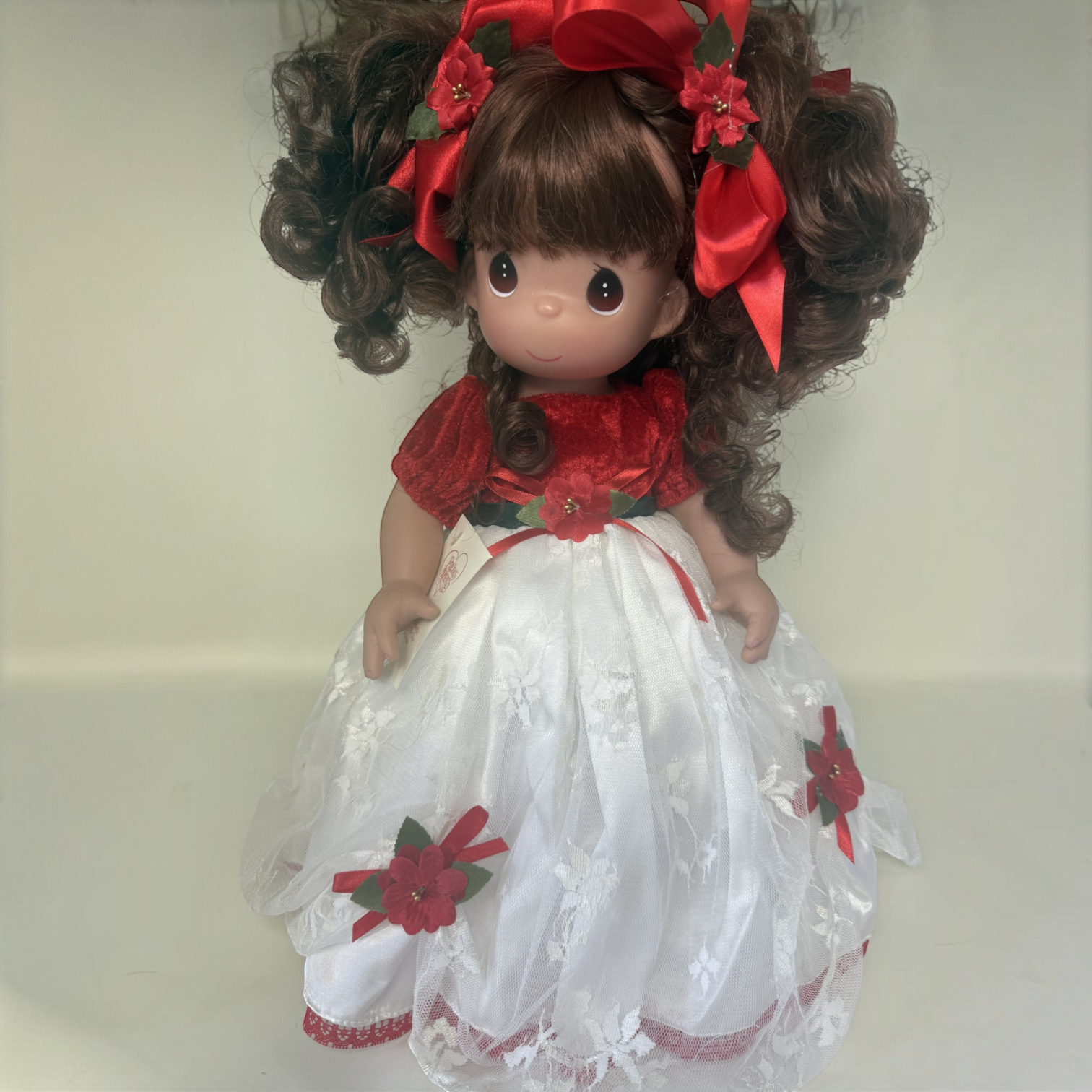 The Doll Maker one-of-a-kind brunette doll in a white lace and red velvet Christmas gown with floral hair ribbons
