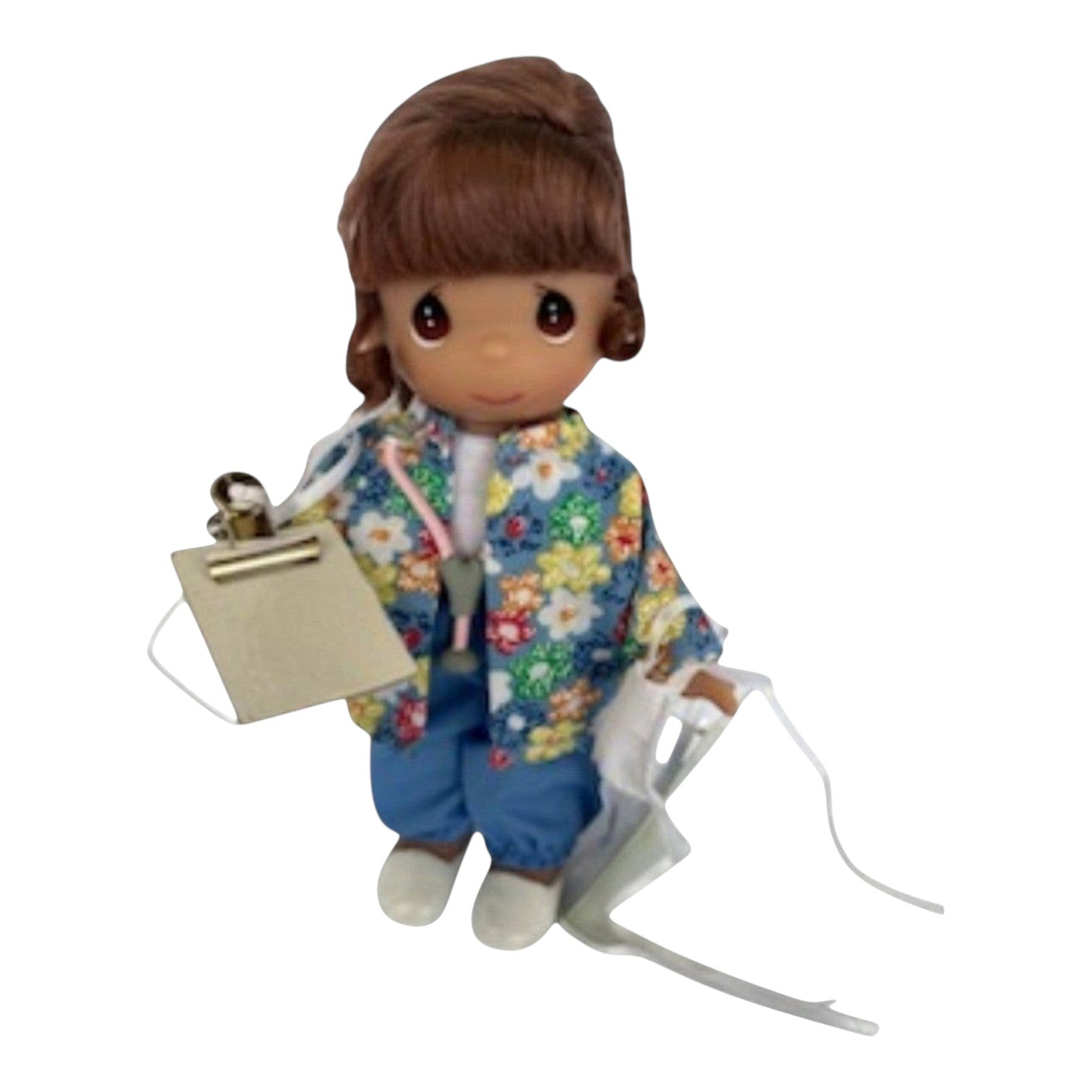 The Doll Maker Caring for You brunette nurse vinyl doll wearing a floral jacket and holding a clipboard