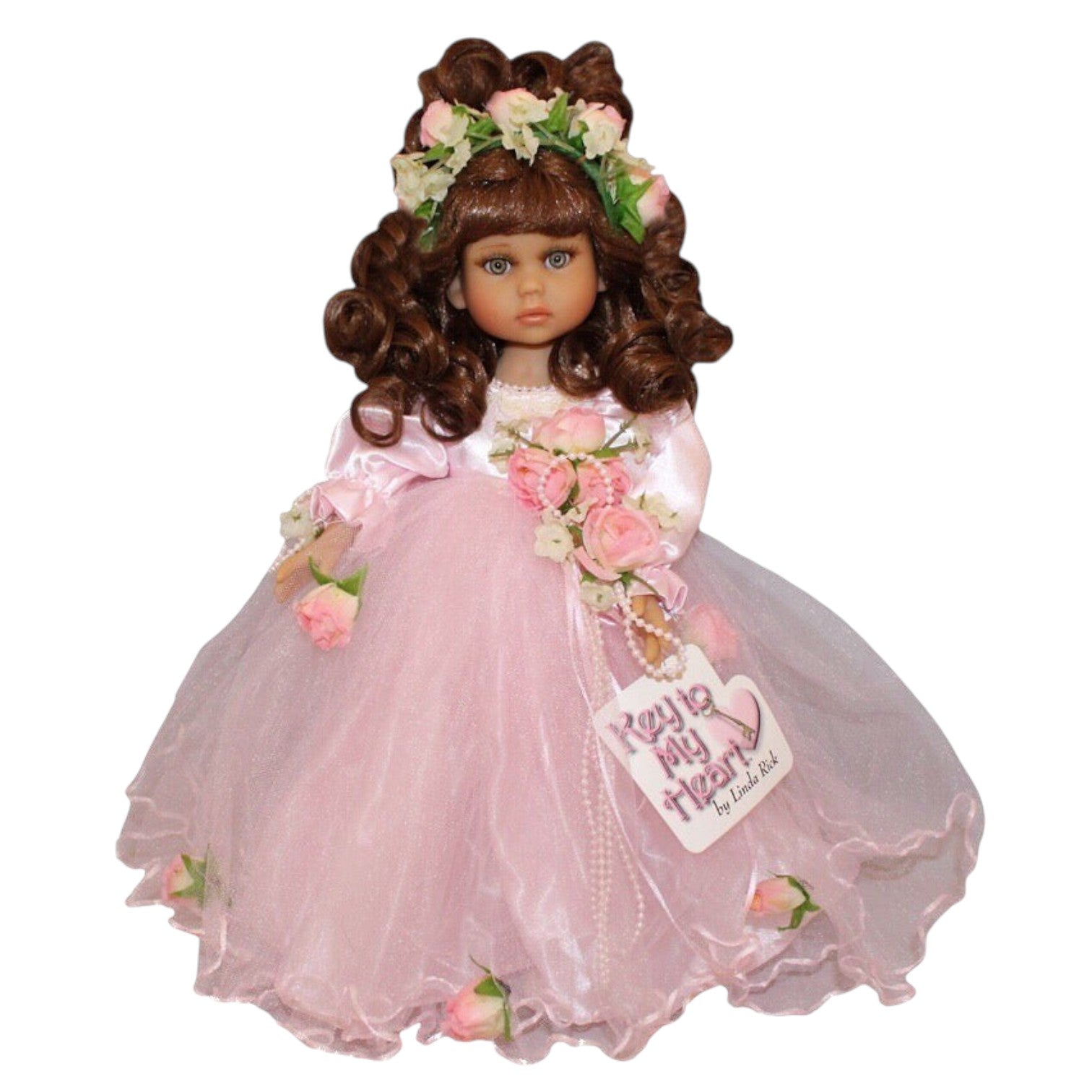The Doll Maker Pretty As Can Be brunette doll in a pink layered tulle gown with floral crown and bouquet