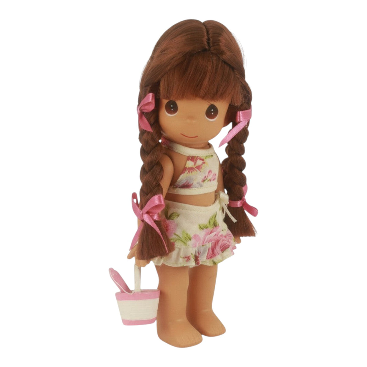 The Doll Maker Sand Castle Dreams 9-inch brunette vinyl doll with braided hair, floral outfit, and pink sand bucket.