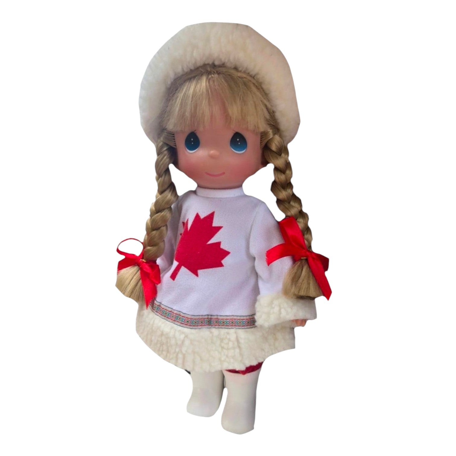 The Doll Maker 12-inch collectible doll wearing a white Canadian-themed outfit with a red maple leaf and fur trim.