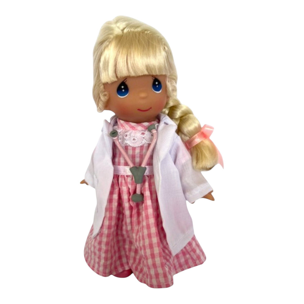 The Doll Maker 7-inch Caring Heart doctor doll with blonde hair, pink gingham dress, and white lab coat with stethoscope