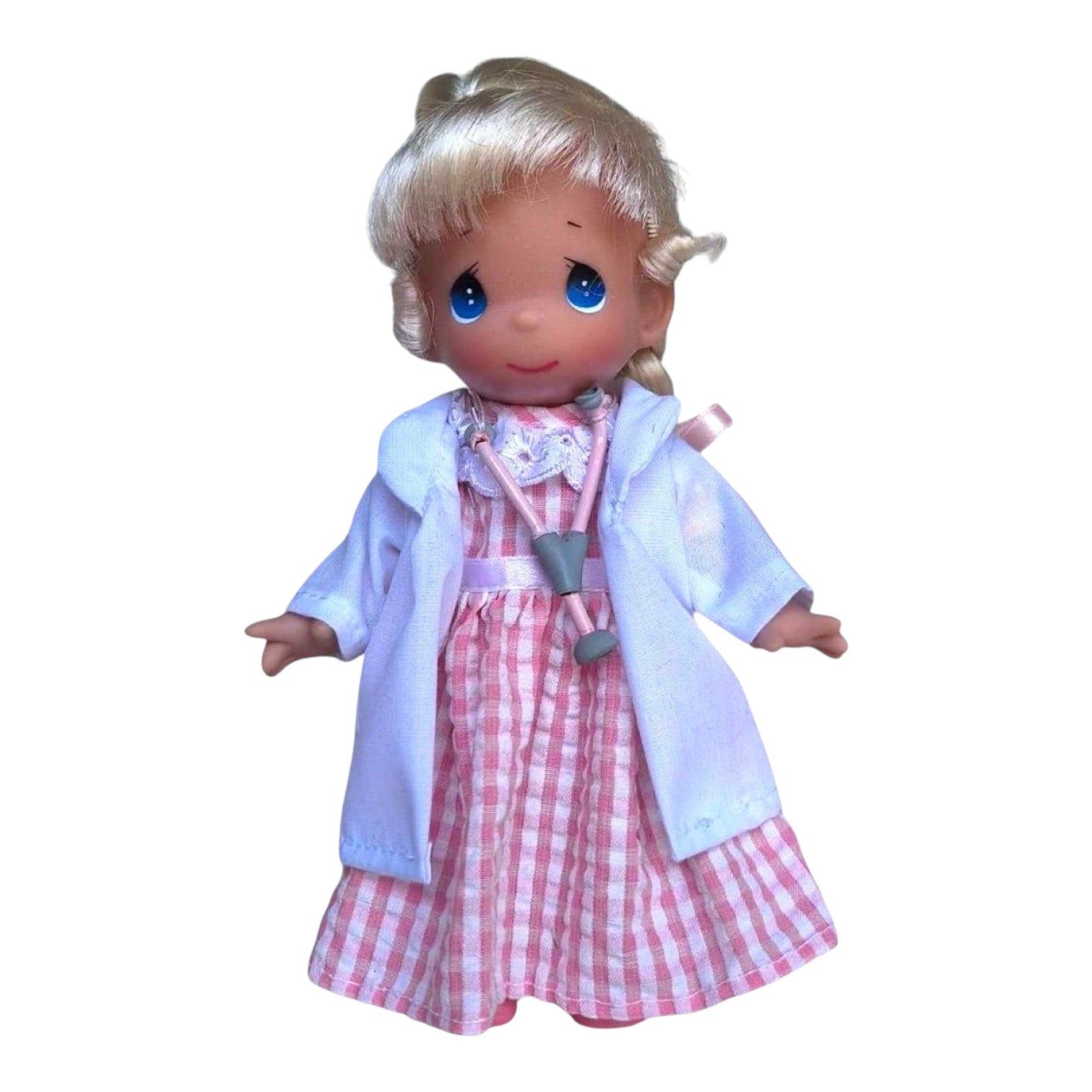 The Doll Maker 7-inch Caring Heart doctor doll with blonde hair, wearing a white coat over a pink gingham dress.