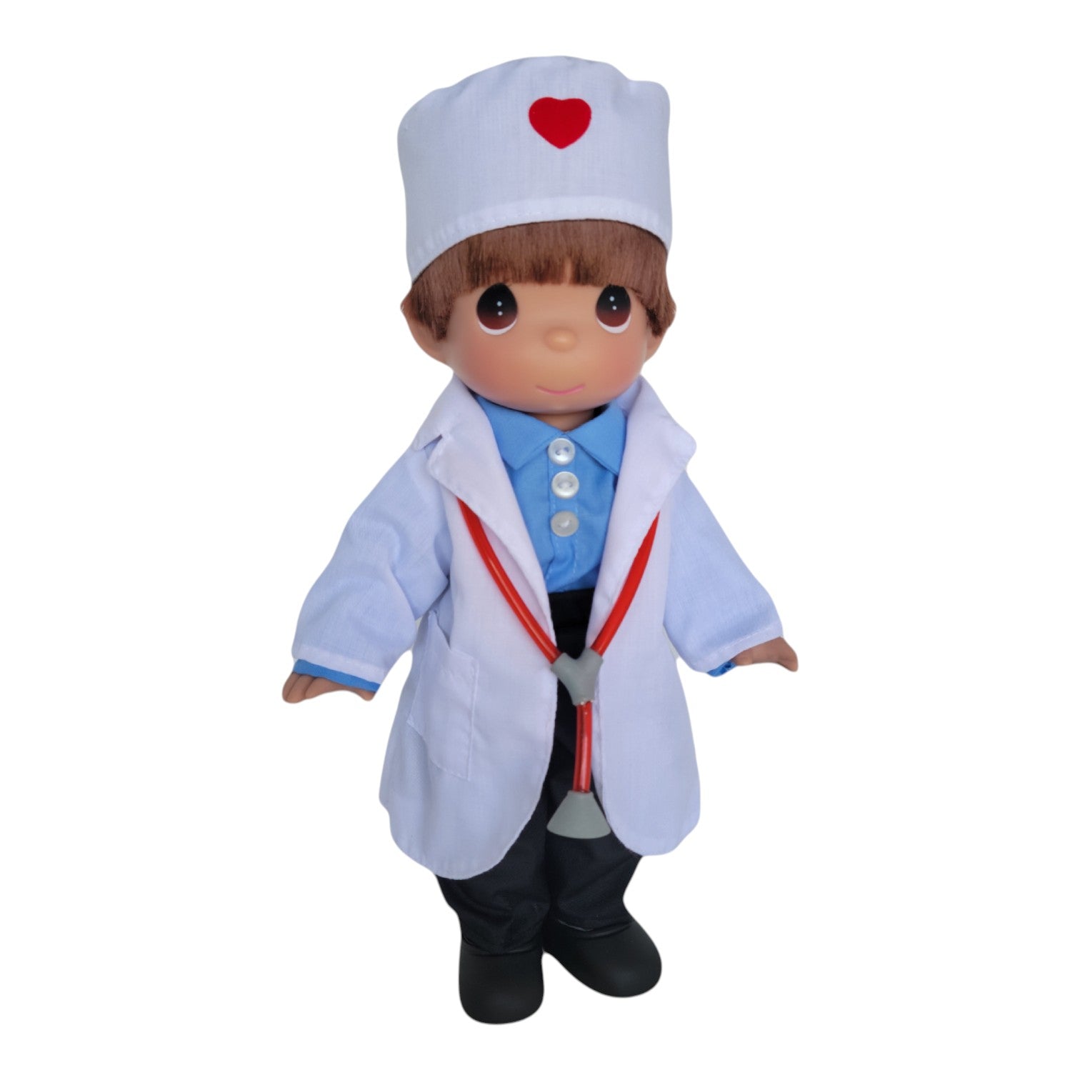 The Doll Maker 12-inch Caring Heart doctor vinyl doll wearing a white lab coat, blue shirt, and heart-accented cap.