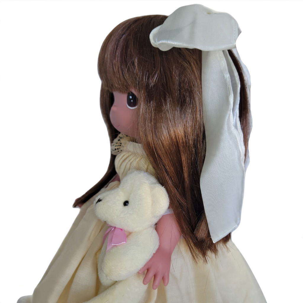 The Doll Maker Cherish Me Always 12-inch vinyl doll with auburn hair, wearing an ivory lace gown and holding a bear.