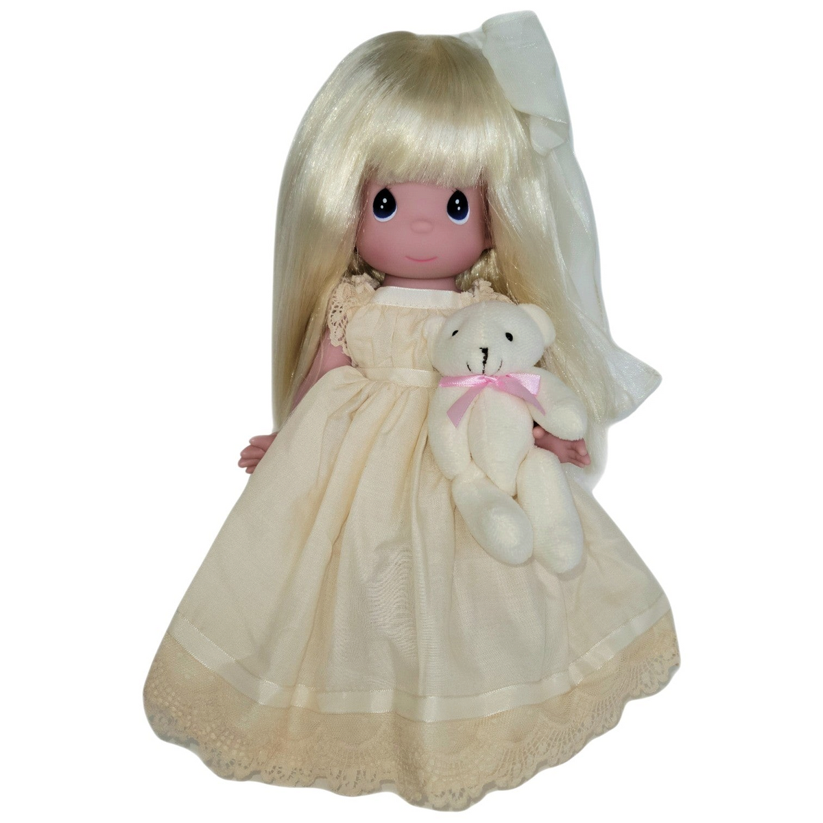 The Doll Maker Cherish Me Always 12-inch blonde vinyl doll wearing an ivory lace gown and holding a small teddy bear.