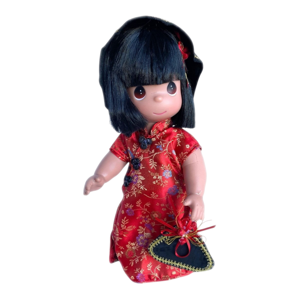 The Doll Maker 12-inch China collectible doll wearing a red floral traditional dress with black fan and matching hat