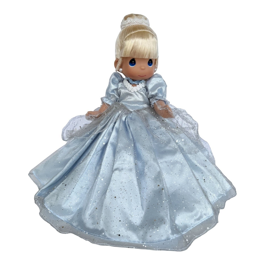 The Doll Maker 12-inch Cinderella vinyl doll wearing a sparkling blue ballgown with a white tiara and pearl earrings.