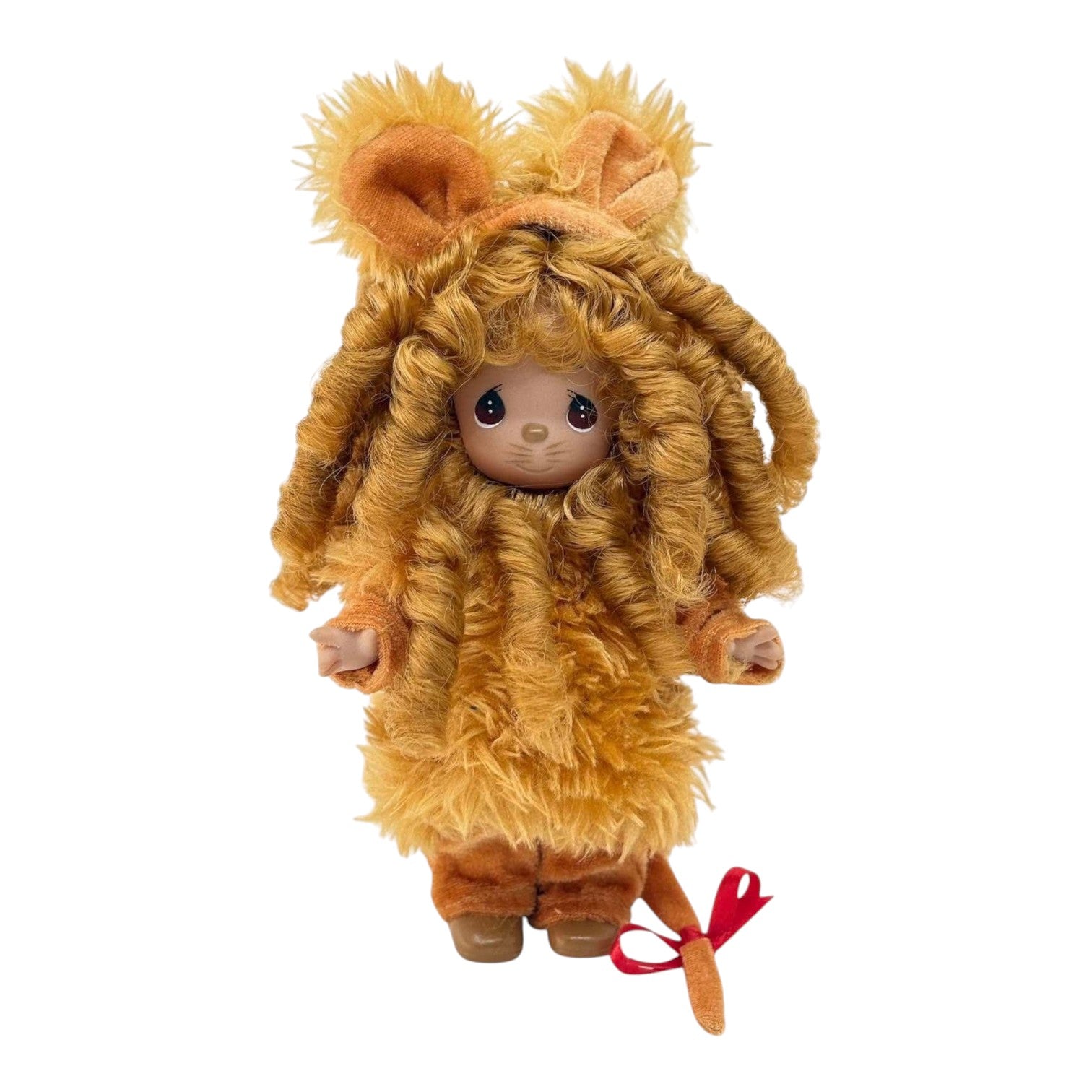 The Doll Maker 7-inch Cowardly Lion vinyl doll from The Wizard of Oz with curly brown fur and a red tail ribbon.
