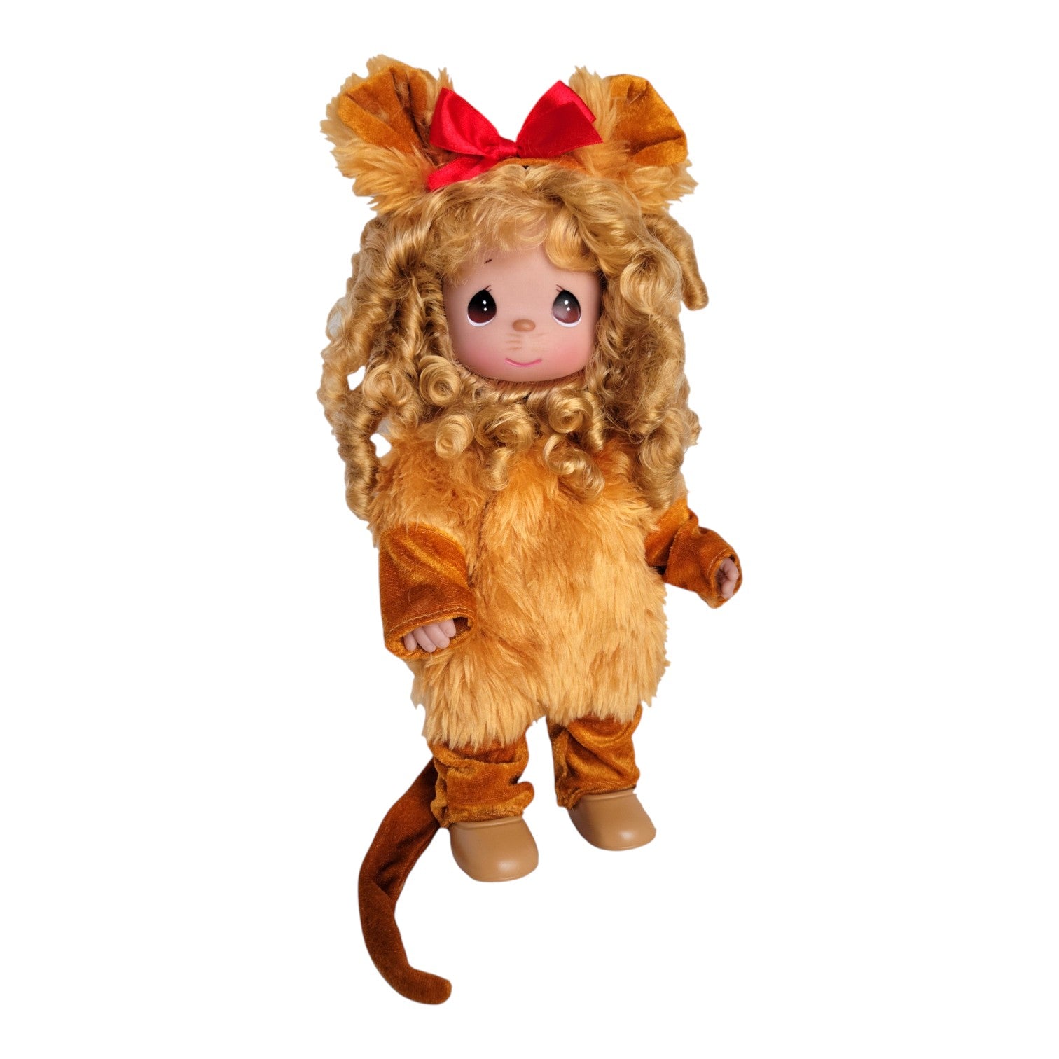 The Doll Maker 12-inch Cowardly Lion vinyl doll from The Wizard of Oz with curly blonde hair and a red bow.