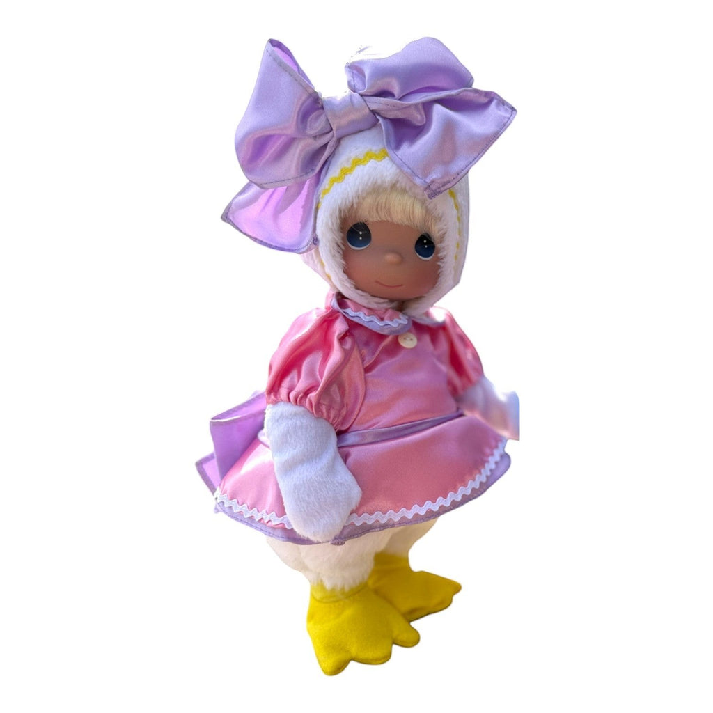 The Doll Maker 12-inch Daisy Duck collectible doll wearing a pink satin dress and a large purple bow