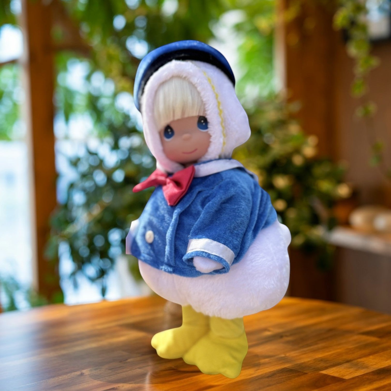 The Doll Maker 12-inch collectible vinyl doll in a Donald Duck outfits featuring a blue sailor jacket with a red bow tie and a blue hat